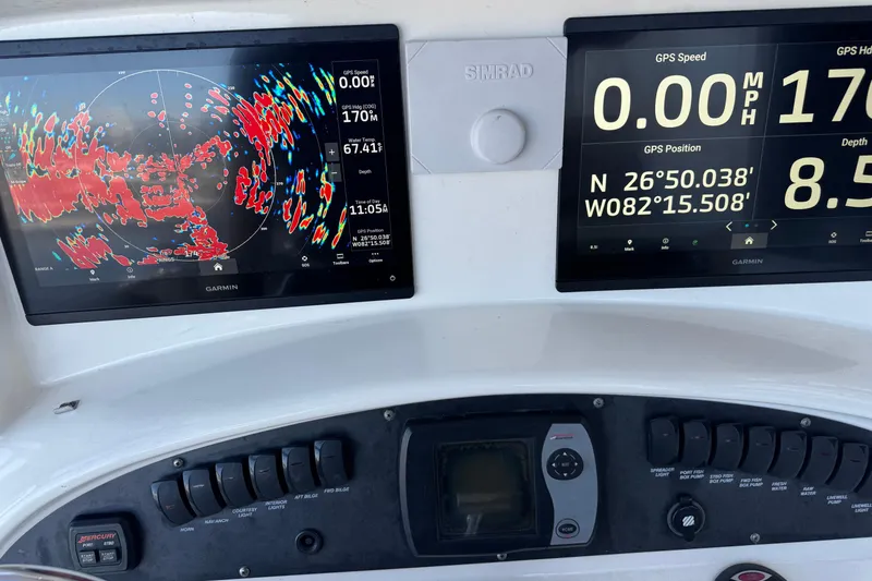 Slide: The Image of Dashboard of a 2006 Boston Whaler 320 Outrage with Garmin navigation displays. - 19