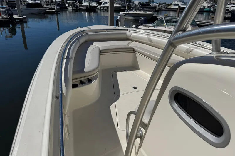 Slide: The Image of 2006 Boston Whaler 320 Outrage boat interior at marina, featuring spacious seating area. - 20