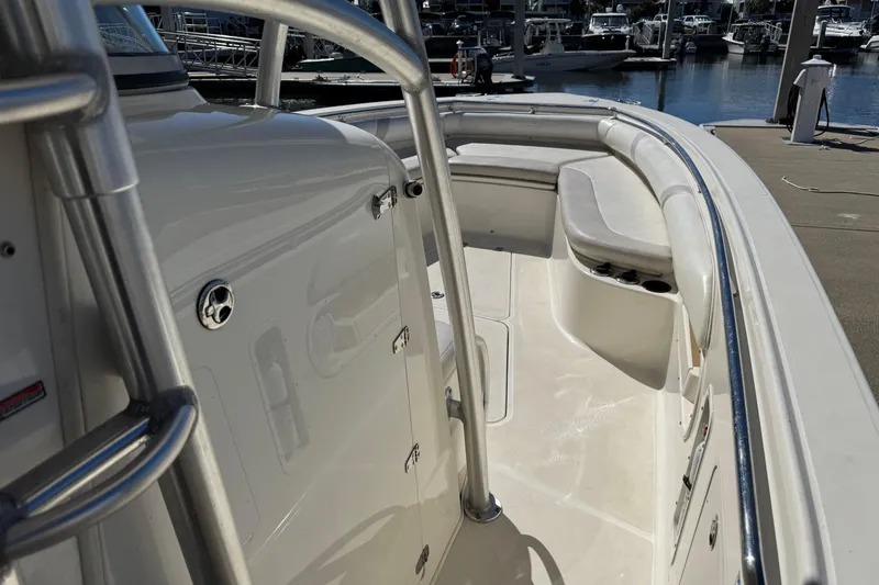 Slide: The Image of 2006 Boston Whaler 320 Outrage boat interior with seating and railing at marina. - 21