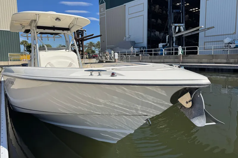 Slide: The Image of 2006 Boston Whaler 320 Outrage boat docked near a marina facility. - 24