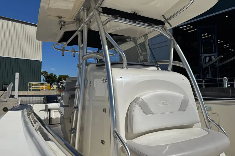Slide: The Image of 2006 Boston Whaler 320 Outrage boat with sleek design and sturdy structure at a marina. - 26