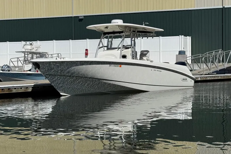 Slide: The Image of 2006 Boston Whaler 320 Outrage boat docked in marina, reflecting on water. - 3