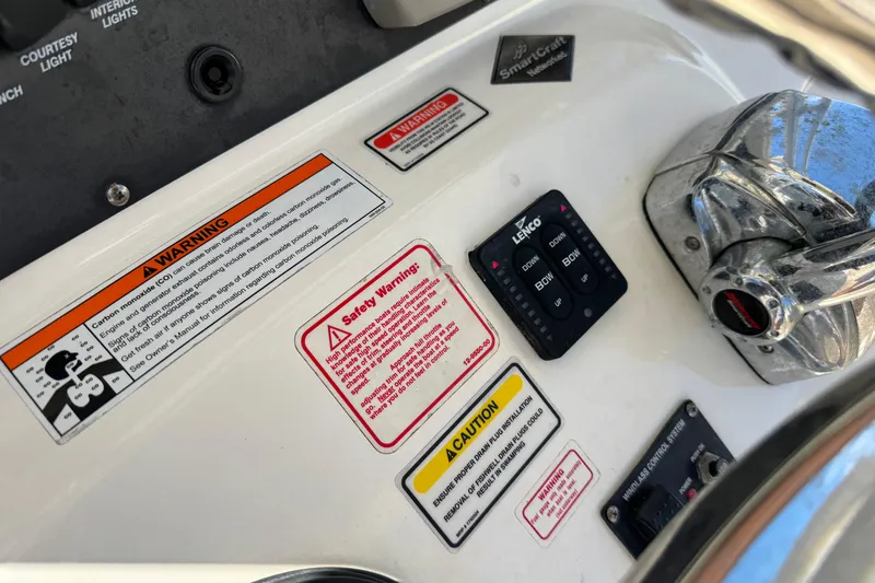 Slide: The Image of Control panel of a 2006 Boston Whaler 320 Outrage with warning labels and controls. - 31