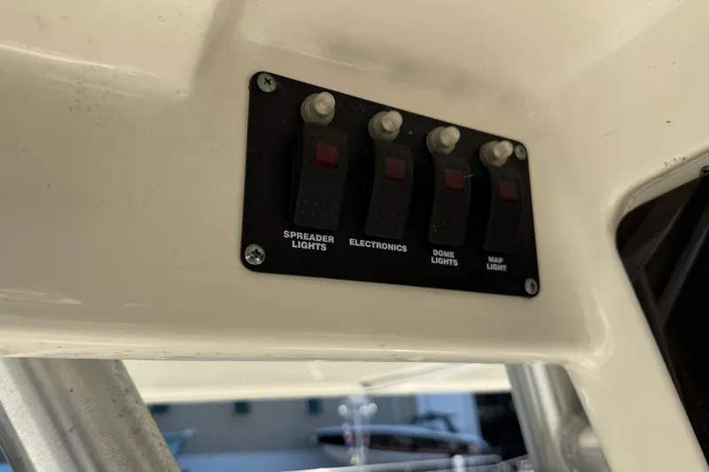 Slide: The Image of Control panel on a 2006 Boston Whaler 320 Outrage boat with labeled switches. - 34