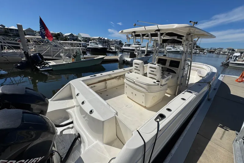 Slide: The Image of 2006 Boston Whaler 320 Outrage boat docked at marina, featuring dual engines. - 35
