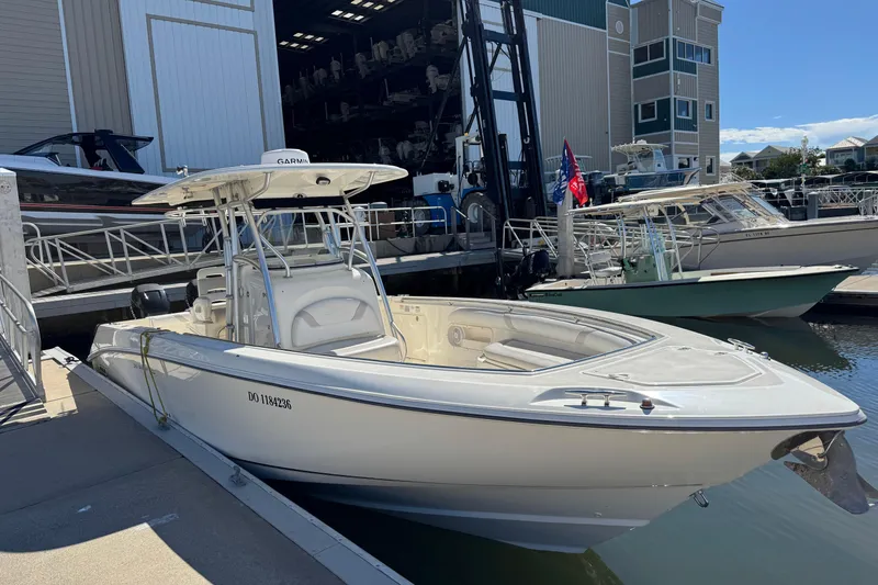 Slide: The Image of 2006 Boston Whaler 320 Outrage docked at marina, featuring sleek design and spacious deck. - 36