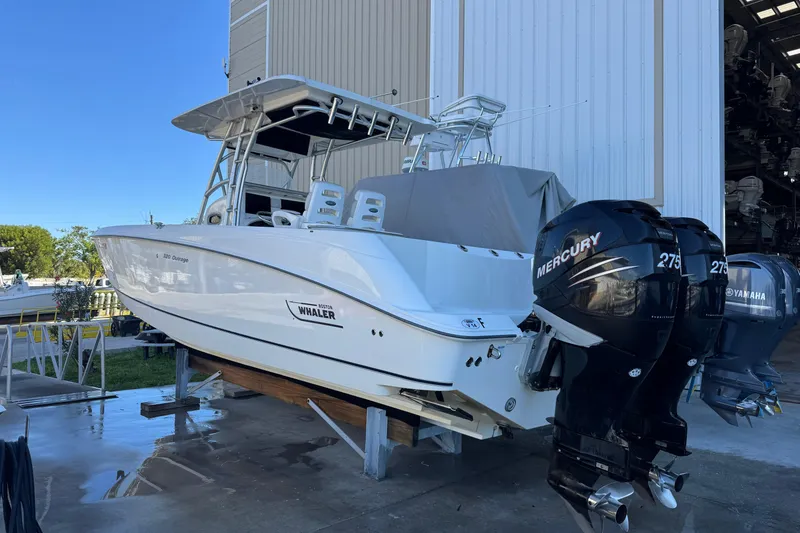 Slide: The Image of 2006 Boston Whaler 320 Outrage boat with dual Mercury engines in storage facility. - 5