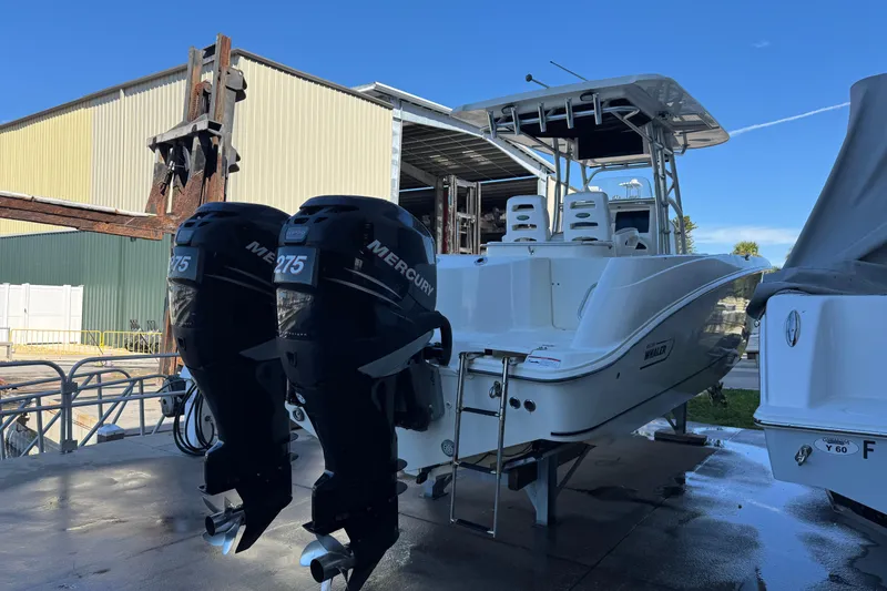 Slide: The Image of 2006 Boston Whaler 320 Outrage with twin Mercury 275 engines, docked outdoors. - 6