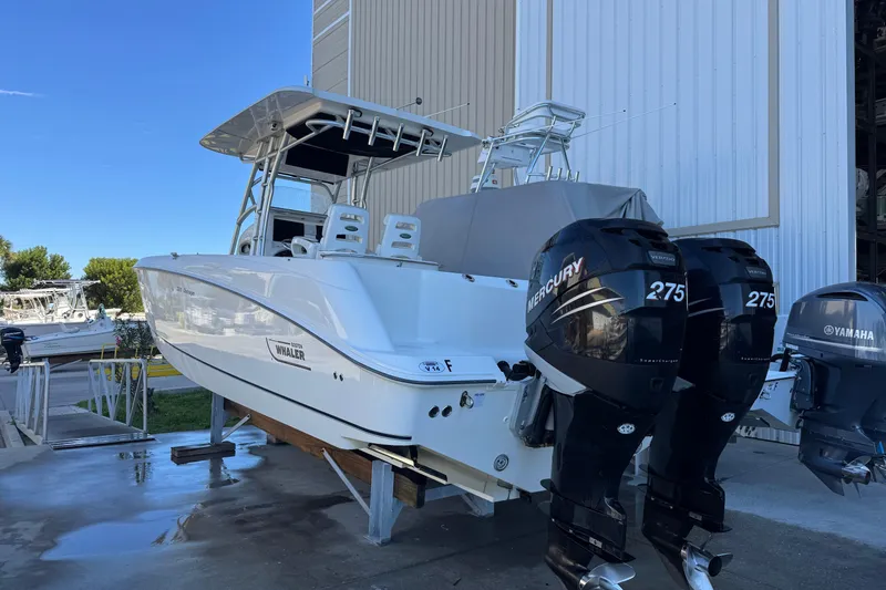 Slide: The Image of 2006 Boston Whaler 320 Outrage with twin Mercury 275 engines, docked outdoors. - 7
