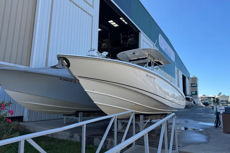Slide: The Image of 2006 Boston Whaler 320 Outrage boat docked at marina, side view. - 8