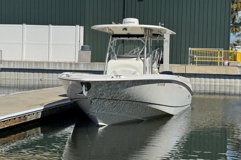 Slide: The Image of 2006 Boston Whaler 320 Outrage boat docked at marina, front view. - 9