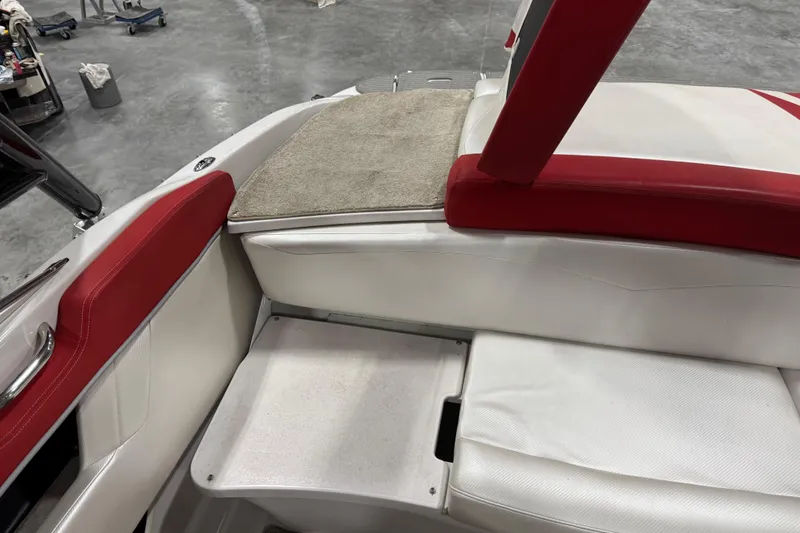 Slide: The Image of 2011 Four Winns 210 Horizon SS boat interior with red and white seating. - 10