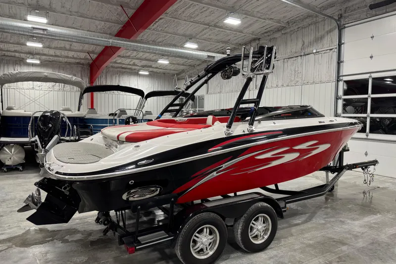 Slide: The Image of 2011 Four Winns 210 Horizon SS boat in a showroom, red and black design. - 3