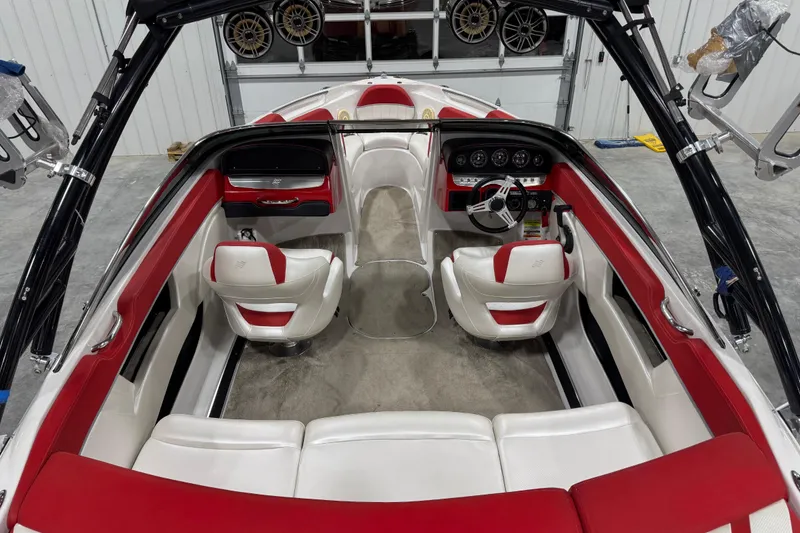 Slide: The Image of 2011 Four Winns 210 Horizon SS boat interior with red and white seating, steering wheel, and dashboard. - 6