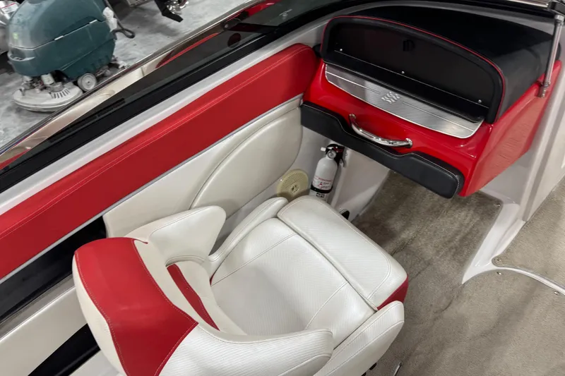 Slide: The Image of 2011 Four Winns 210 Horizon SS boat interior with red and white seating, glove compartment, and fire extinguisher. - 8