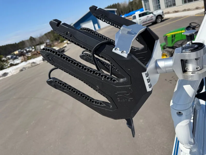 Slide: The Image of Moomba Mondo 2026 boat with wakeboard rack outdoors. - 37