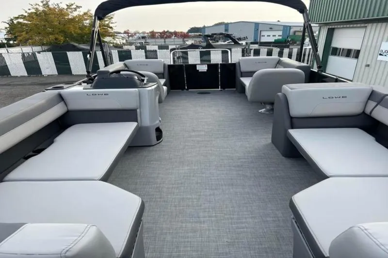 Slide: The Image of 2026 Lowe LS 210 WT pontoon boat with spacious seating and modern design. - 19
