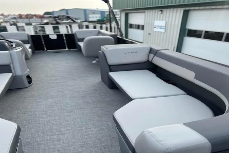 Slide: The Image of 2026 Lowe LS 210 WT boat interior with gray seating and spacious deck. - 21