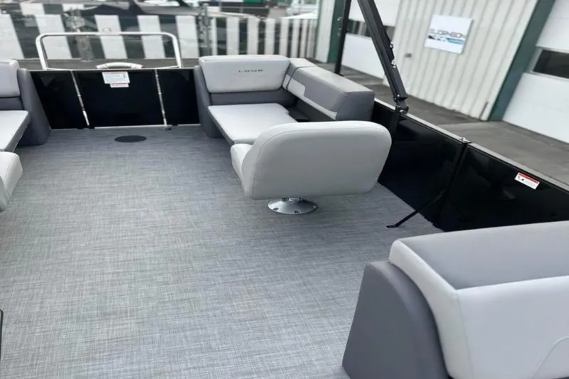 Slide: The Image of 2026 Lowe LS 210 WT boat interior with gray seating and flooring. - 24