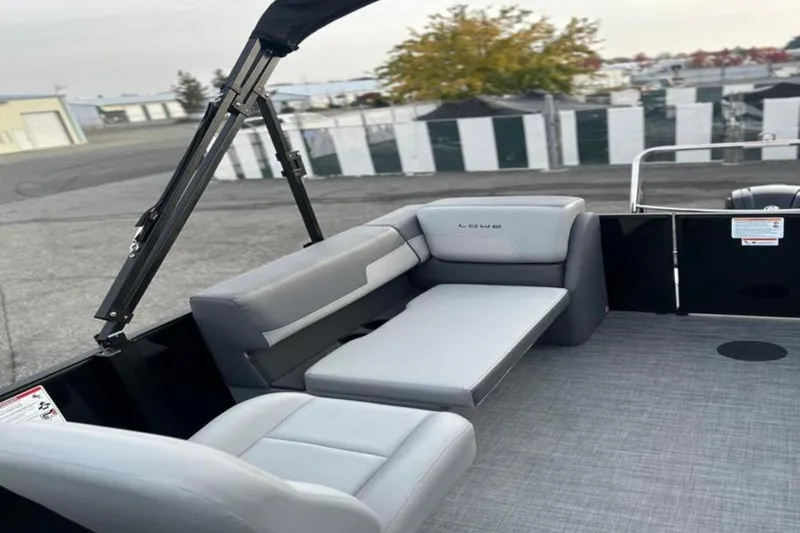 Slide: The Image of 2026 Lowe LS 210 WT boat interior with gray seating and canopy frame. - 25