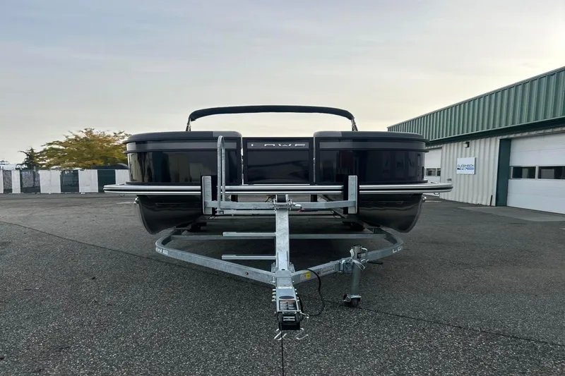 Slide: The Image of 2026 Lowe LS 210 WT pontoon boat on trailer in parking lot. - 3