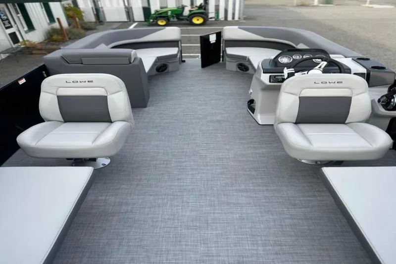 Slide: The Image of 2026 Lowe LS 210 WT boat interior with modern seating and steering console. - 31