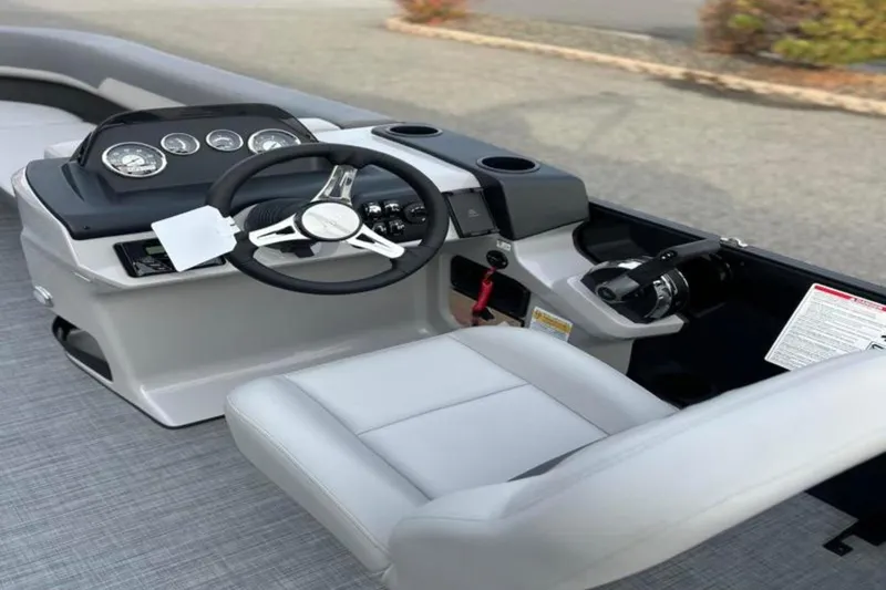 Slide: The Image of 2026 Lowe LS 210 WT boat interior with steering wheel and control panel. - 36