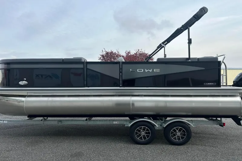 Slide: The Image of 2026 Lowe LS 210 WT pontoon boat on trailer, sleek black design. - 6