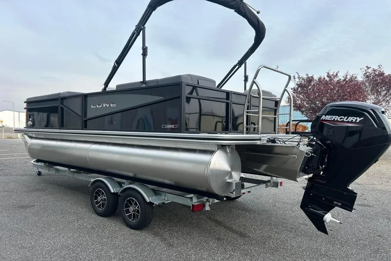 Slide: The Image of 2026 Lowe LS 210 WT pontoon boat with Mercury outboard motor on trailer. - 7