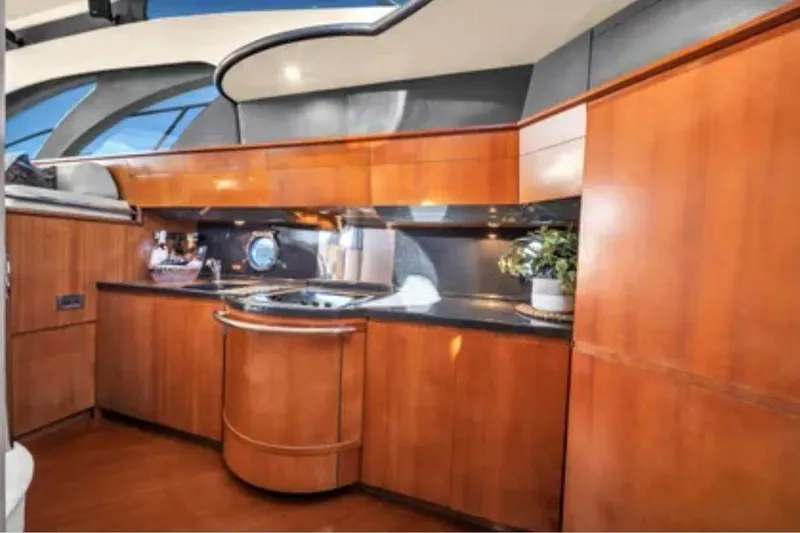 Slide: The Image of Luxurious kitchen interior of 2006 Azimut 50 Fly yacht with wooden cabinetry. - 11