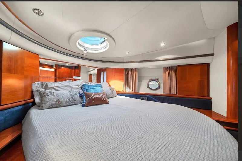 Slide: The Image of Luxurious bedroom interior of 2006 Azimut 50 Fly yacht with elegant wood paneling. - 12