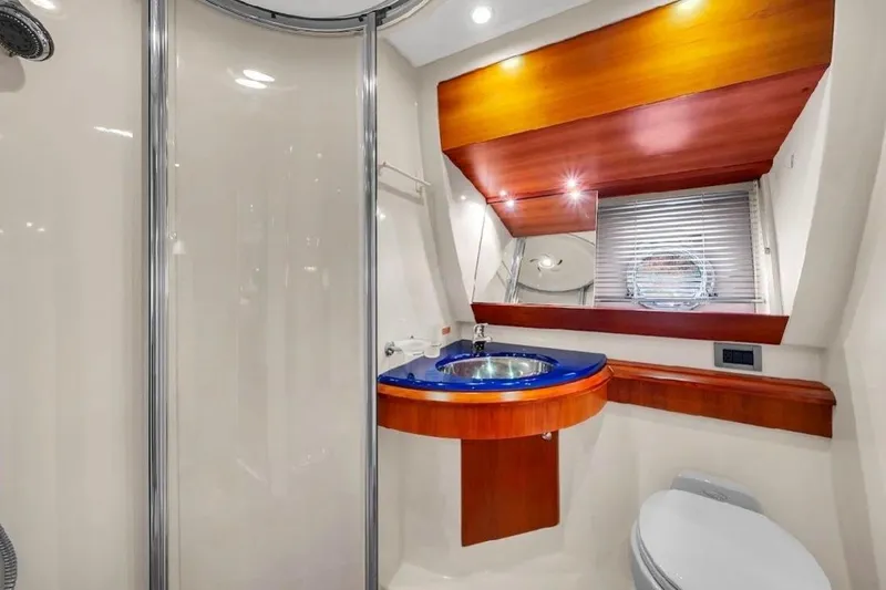 Slide: The Image of Luxurious bathroom in 2006 Azimut 50 Fly yacht with modern fixtures and elegant wood accents. - 14
