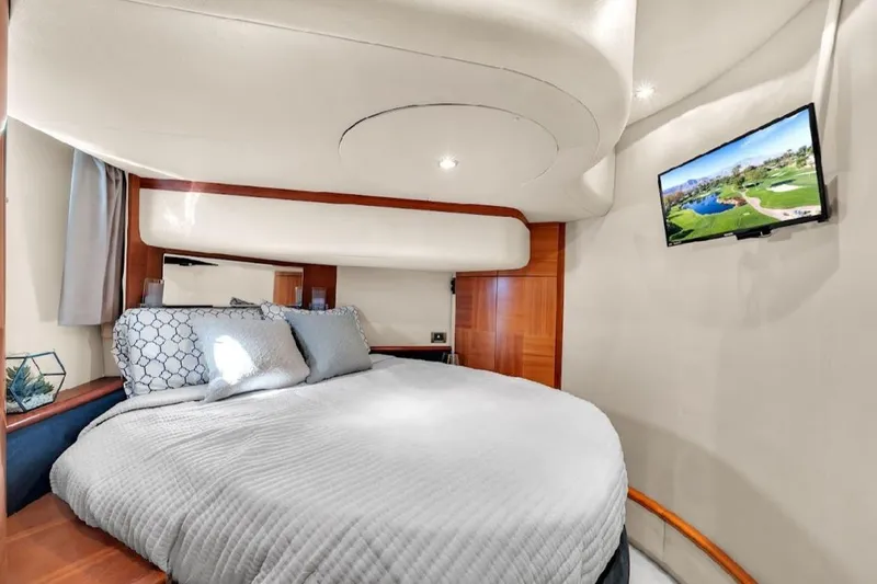 Slide: The Image of Luxurious bedroom interior of 2006 Azimut 50 Fly yacht with cozy bed and wall-mounted TV. - 15
