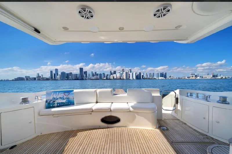 Slide: The Image of Azimut 50 Fly 2006 yacht with city skyline view, featuring spacious deck seating. - 2