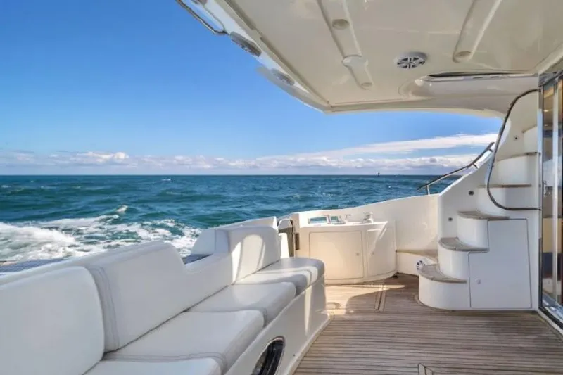 Slide: The Image of Azimut 50 Fly 2006 yacht deck with ocean view, featuring white seating and stairs. - 4