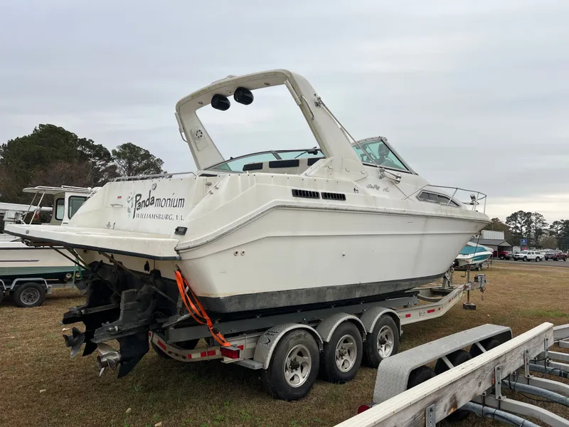 Slide: The Image of 1992 Sea Ray 300 boat on trailer, parked outdoors, overcast sky. - 4