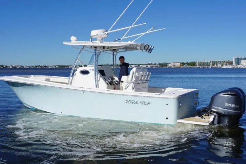 Slide: The Image of 2018 Regulator 28 boat with Yamaha engine cruising on calm waters. - 12