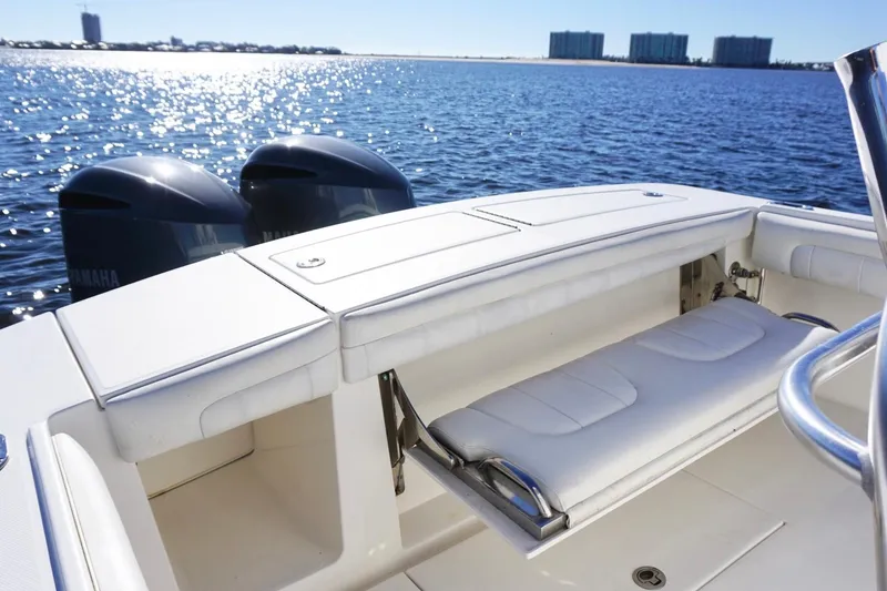 Slide: The Image of 2018 Regulator 28 boat with Yamaha engines, featuring a sleek white seating area on calm waters. - 16