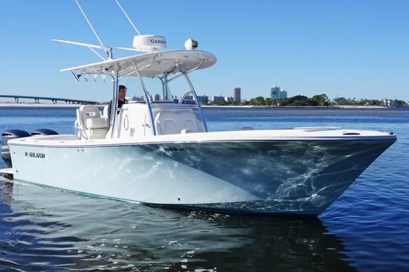 Slide: The Image of 2018 Regulator 28 boat on calm water with city skyline in background. - 3
