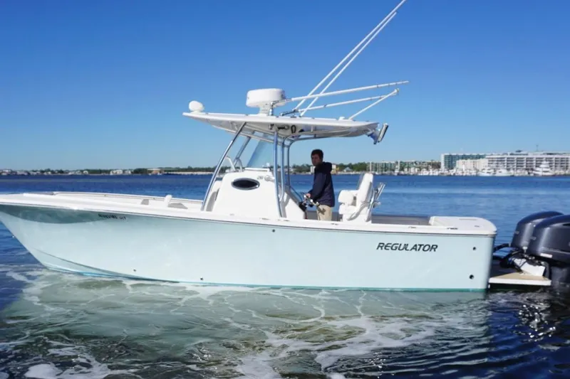 Slide: The Image of 2018 Regulator 28 boat on calm water with clear blue sky. - 4