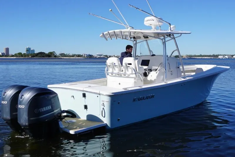 Slide: The Image of 2018 Regulator 28 boat with twin Yamaha engines on calm water. - 7