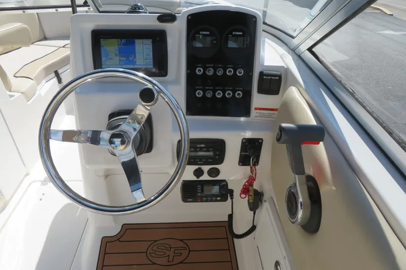 Slide: The Image of 2015 Sea Fox 226 Traveler boat dashboard with steering wheel and control panel. - 27