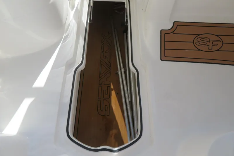 Slide: The Image of 2015 Sea Fox 226 Traveler boat interior with logo and storage compartment. - 41