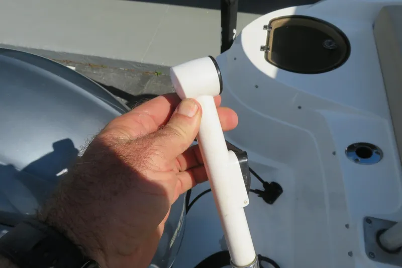 Slide: The Image of Hand holding a part on a 2015 Sea Fox 226 Traveler boat deck. - 46