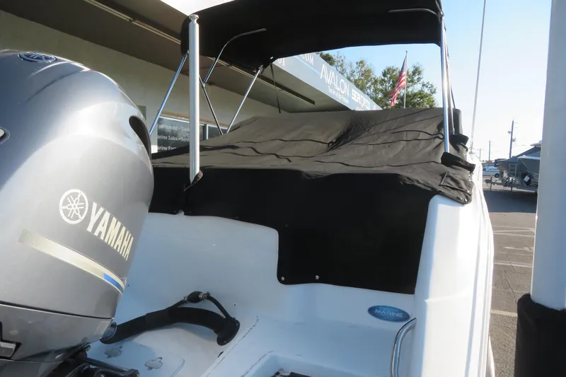 Slide: The Image of 2015 Sea Fox 226 Traveler boat with Yamaha engine, covered and parked outdoors. - 50