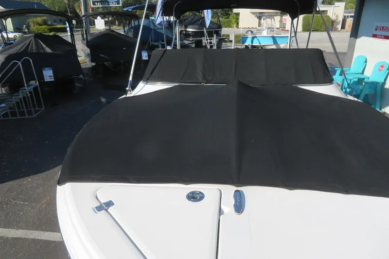 Slide: The Image of 2015 Sea Fox 226 Traveler boat with black cover in a parking lot. - 53