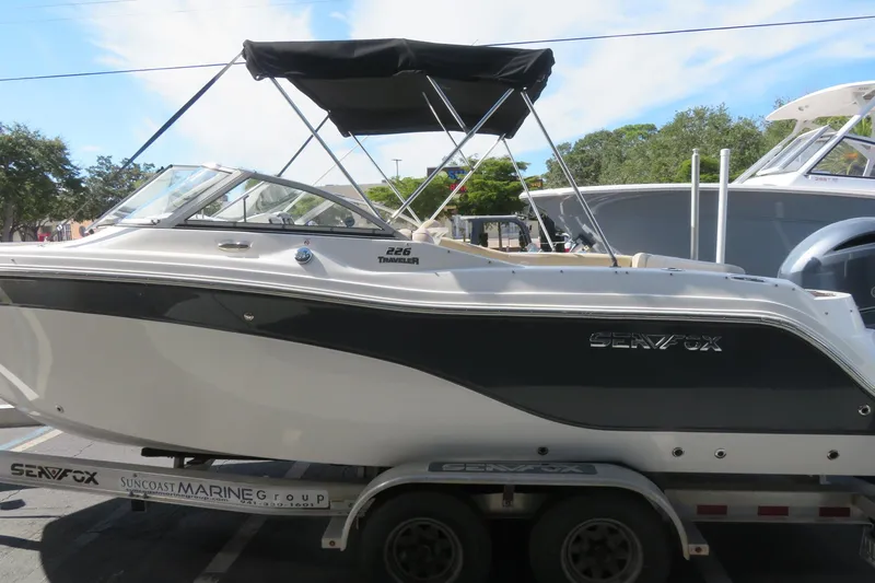 Slide: The Image of 2015 Sea Fox 226 Traveler boat on trailer, featuring sleek design and black canopy. - 8