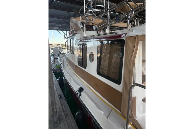 Slide: The Image of 2016 Ranger Tugs R-31 CB docked under shelter, side view. - 11