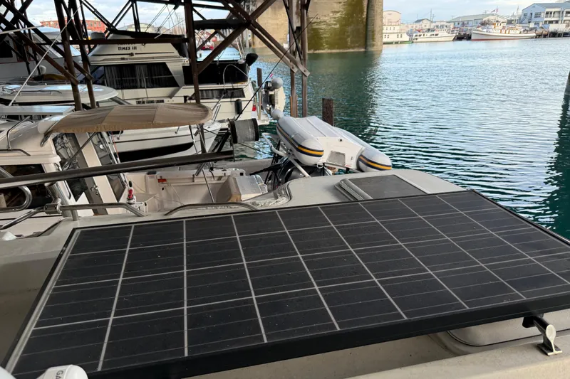 Slide: The Image of 2016 Ranger Tugs R-31 CB with solar panel docked in a marina. - 13