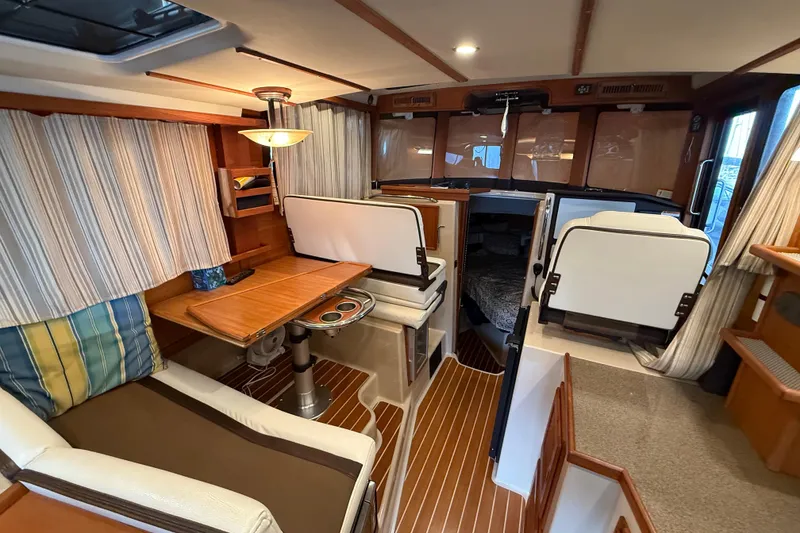 Slide: The Image of Interior of 2016 Ranger Tugs R-31 CB with cozy seating and wooden accents. - 17
